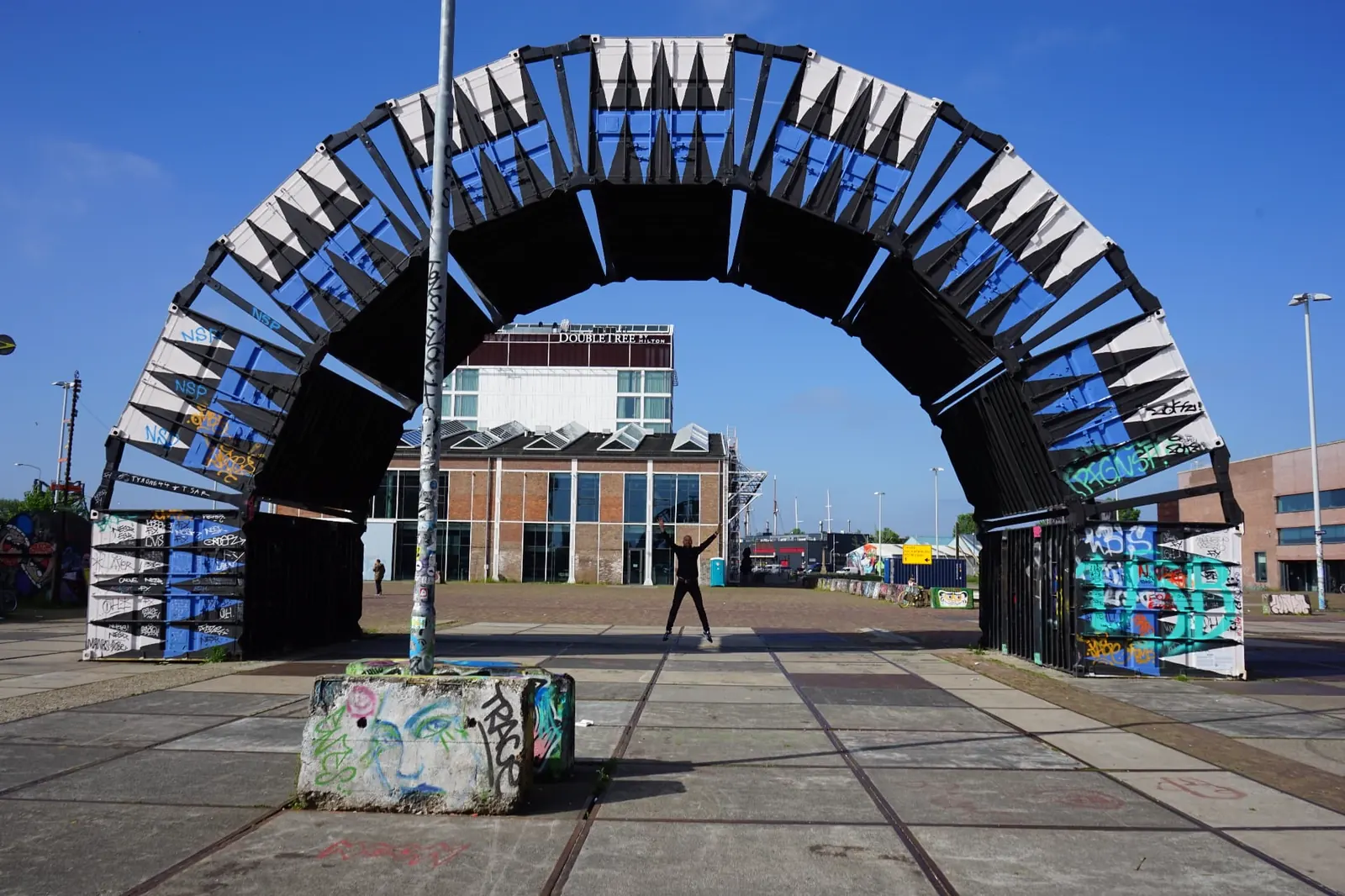 Johnny van Dyck under a large industrial arch